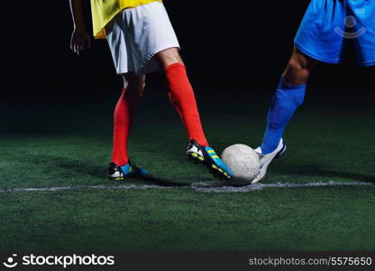 soccer player doing kick with ball on football stadium field isolated on black background