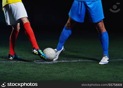 soccer player doing kick with ball on football stadium field isolated on black background