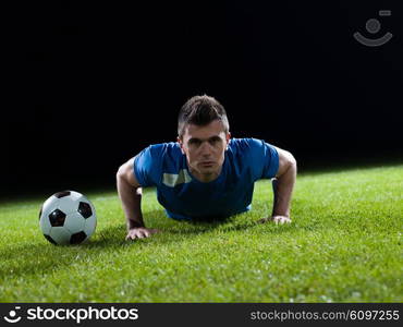 soccer player doing kick with ball on football stadium field isolated on black background