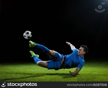 soccer player doing kick with ball on football stadium field isolated on black background