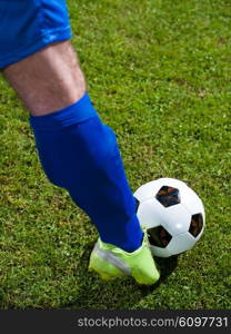 soccer player doing kick with ball on football stadium field isolated on black background