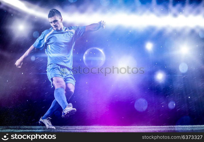 soccer player doing kick with ball on football stadium field isolated on black background