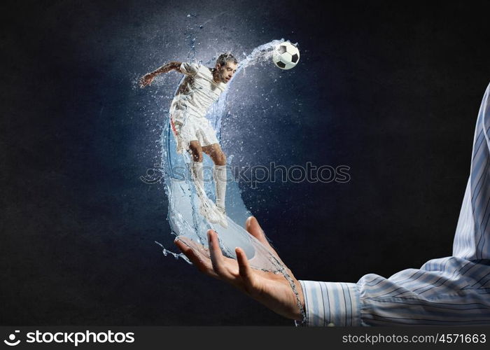 Soccer player kicking ball. Soccer player with ball in action in male palm