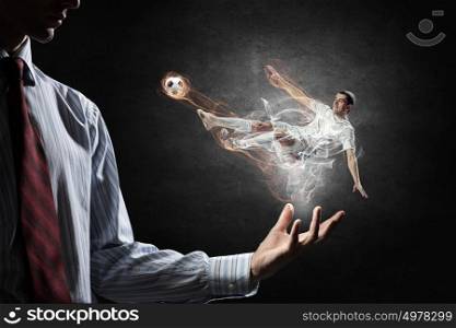 Soccer player kicking ball. Soccer player with ball in action in male palm