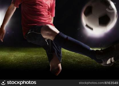 Soccer player kicking soccer ball