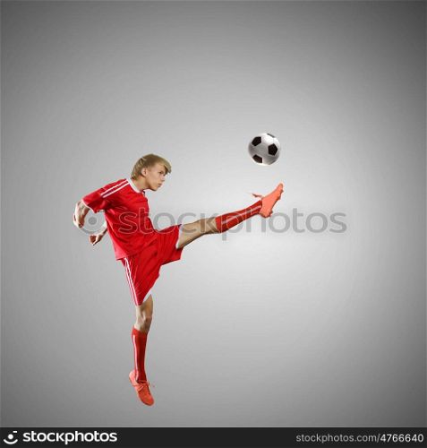 Soccer player. Soccer player kicking ball isolated over white background