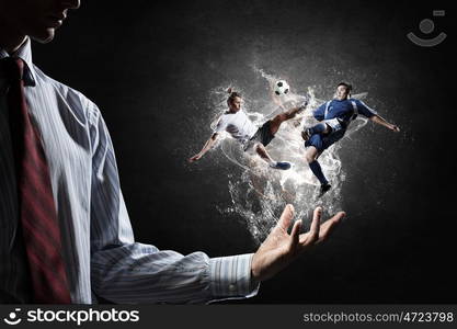 Soccer players fighting for ball. Two soccer players with ball in action in male palm