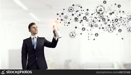 Social connectivity concept. Concept of connection with businessman in office spraying social net concept from balloon
