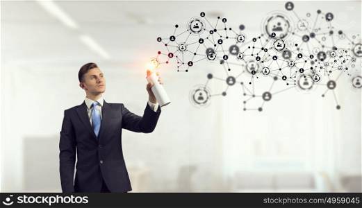 Social connectivity concept. Concept of connection with businessman in office spraying social net concept from balloon