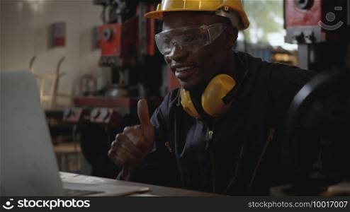 Social distance group of industrial worker, American industrial black young worker man with yellow helmet having teleconference or video conference calls meeting remotely and discussion about project