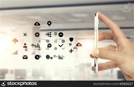 Social media and cloud computing. Smartphone in hand and cloud computing user interface