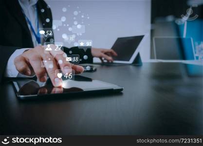 Social media and Marketing virtual icons screen concept.businessman working with smart phone and digital tablet and laptop computer in modern office with glass reflected view