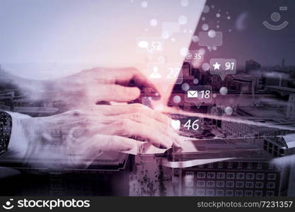 Social media and Marketing virtual icons screen concept.close up of businessman hand working with smart phone and laptop and digital tablet computer in modern office with London city exposure