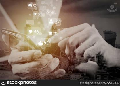 Social media and Marketing virtual icons screen concept.businessman hand working with mobile phone and laptop and digital tablet computer in modern office with London city exposure