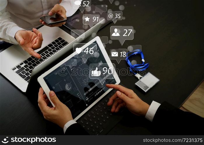 Social media and Marketing virtual icons screen concept.co working team meeting concept,businessman using smart phone and digital tablet and laptop computer and name tag in modern office
