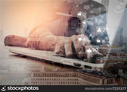 Social media and Marketing virtual icons screen concept.businessman working with smart phone and laptop computer on wooden desk in modern office with virtual icons interface