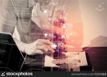 Social media and Marketing virtual icons screen concept.businessman in pink t-shirt working with smart phone and digitl tablet computer on wooden desk in modern office with London city exposure