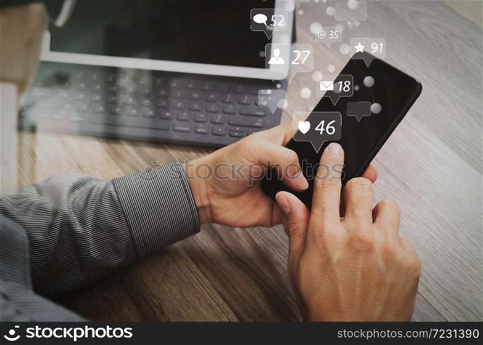 Social media and Marketing virtual icons screen concept.Hand using mobile payments online shopping,omni channel,icon customer network,in modern office wooden desk, blank interface screen,filter effect
