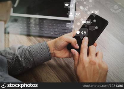 Social media and Marketing virtual icons screen concept.Hand using mobile payments online shopping,omni channel,icon customer network,in modern office wooden desk, blank interface screen,filter effect