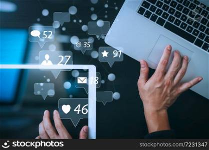 Social media and Marketing virtual icons screen concept.cyber security internet and networking concept.Businessman hand working with laptop computer and digital tablet background