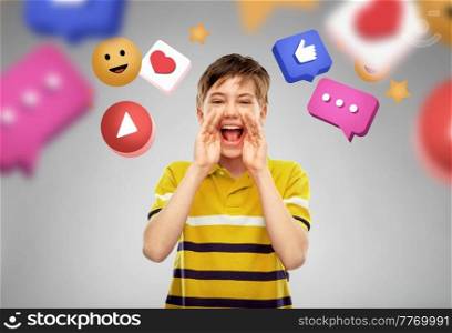 social media and people concept - happy little boy in polo t-shirt shouting or calling over internet icons on grey background. boy shouting or calling over internet icons