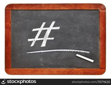 social media concept - hashtag in white chalk on a vintage slate blackboard. blackboard