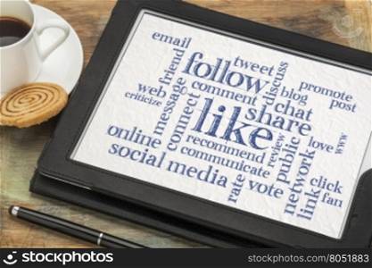 social media concept - like, share, follow word cloud on a digital tablet with a cup of coffee