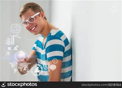 Social media concept. Young handsome man using virtual interface with lots of web and social media icons