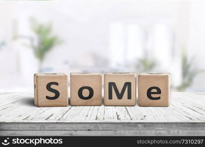 Social media slang word SoMe sign on a wooden table in a living room