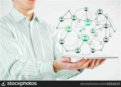 Social network structure as concept. Close view of businessman holding tablet presenting social network concept