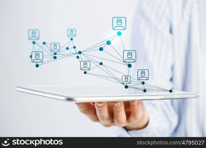 Social network structure as concept. Close view of businessman holding tablet presenting social network concept