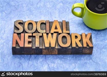 social network - word abstract in vintage letterpress wood type with a cup of coffee