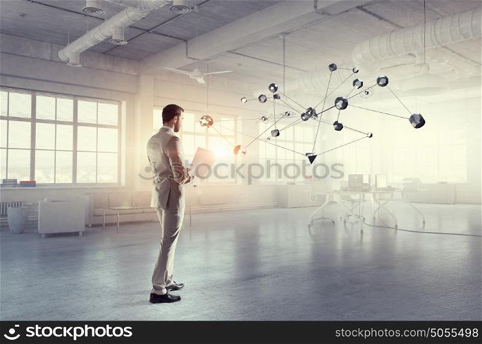 Social networking technologies. Businessman in modern interior and connection concept. Mixed media