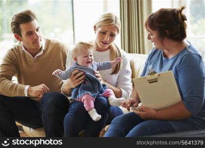 Social Worker Visiting Family With Young Baby