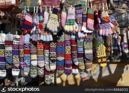 Socks and wool gloves on the line in market place, Turkey