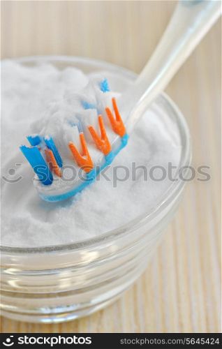 sodium bicarbonate (baking soda) and a toothbrush
