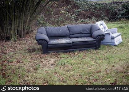Sofa and a chair on grass