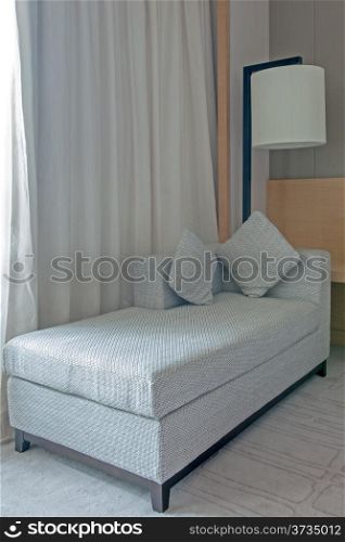 Sofa near the curtain in the hotel room