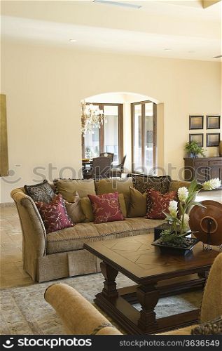 Sofa with cushions and wooden coffee table