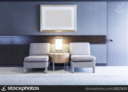Sofas with lamp and blank photo frame on wall in room with light. Sofas with lamp and blank photo frame on wall in room with light. Architecture, living room concept.