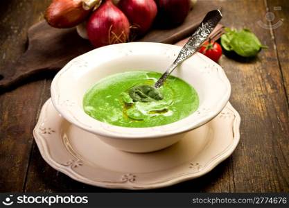 Soft and delicious spinach cream soup on wooden table