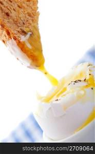 Soft-Boiled egg with toast dripping in yolk. A popular European breakfast.