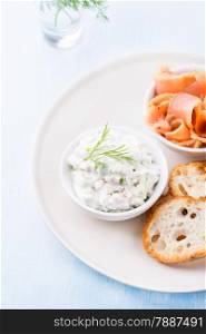 Soft cheese spread with salmon and green onions, top view, selective focus
