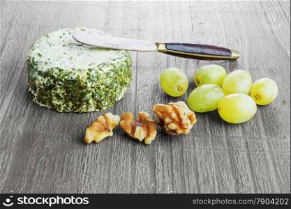 Soft cheese with spring onion and chives on retro wooden desk