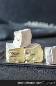 Soft cheese with white and blue mold: cross section