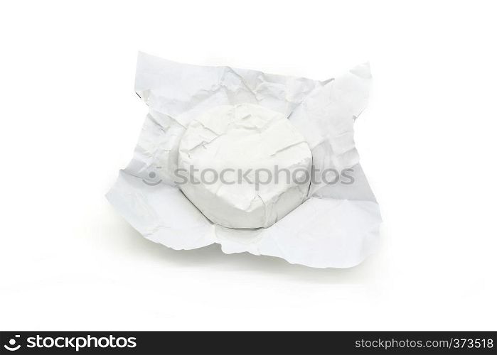 Soft cheese with white mold Brie in unwrapped packaging isolated on a white background