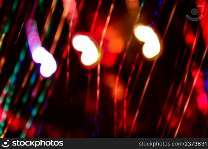 Soft defocused red holidays light background. Red bokeh holiday glitter background. Valentines day defocused red background.
