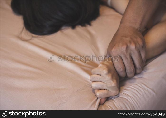 Soft focus a hairy man's hand holding a woman hand for rape and sexual abuse concept