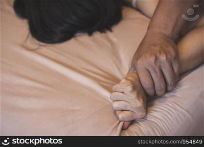 Soft focus a hairy man's hand holding a woman hand for rape and sexual abuse concept