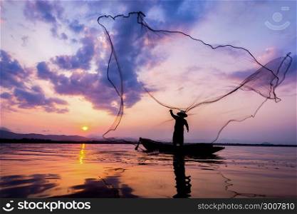 Soft focus and Fisherman of Bangpra Lake in action for fishing Thailand.